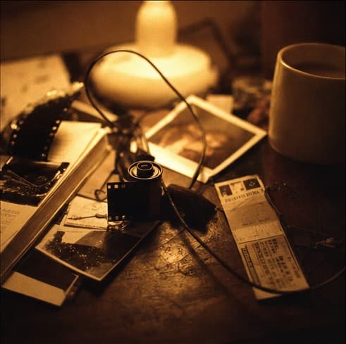Film, ticket stubs and notes scattered on a desk