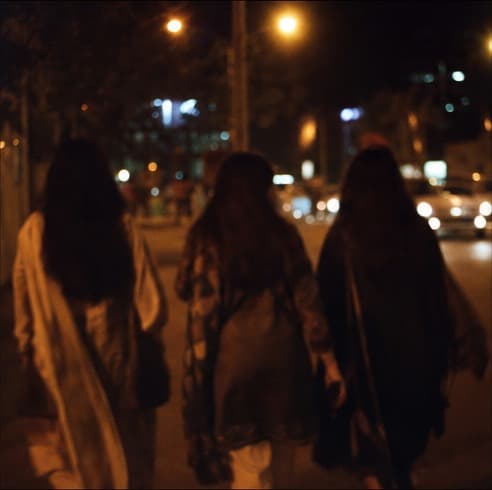 Friends walking under street lights