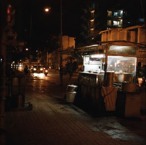 A food cart on a quiet street at night